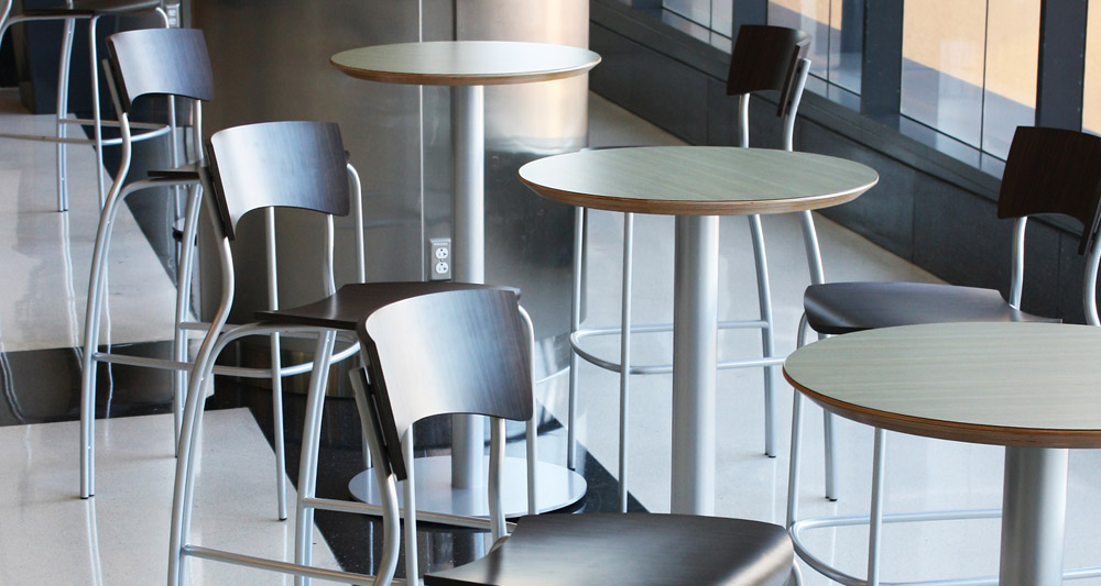metal tube tables and chairs lined up in an office space